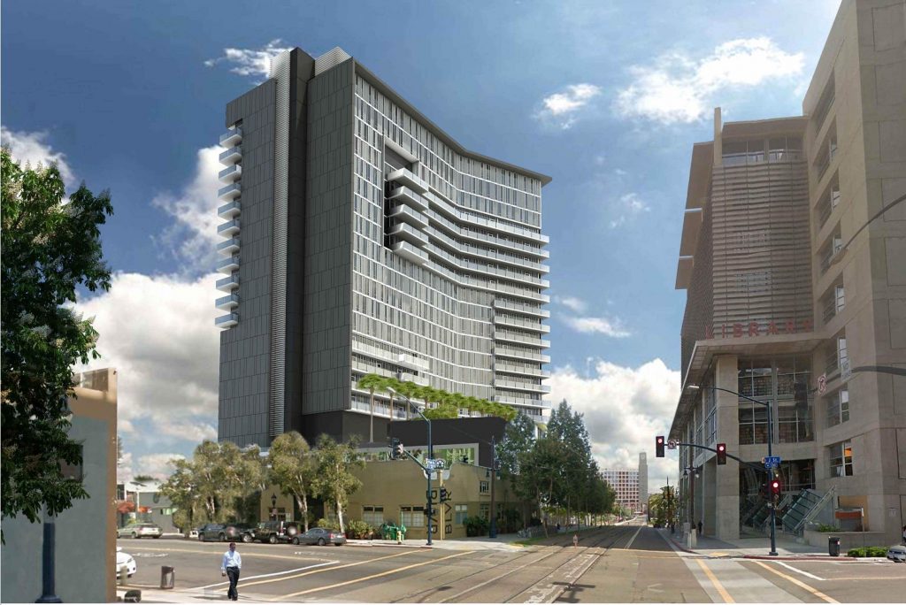 A modern high-rise building with a sleek, curved design by Level 10 Construction stands amid urban structures on a sunny day. A lone pedestrian crosses the street in the foreground, and a few trees are visible near the base of this California-based general contractor's masterpiece.