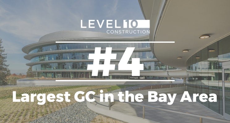 A modern curved glass building with a caption overlay: Level 10 Construction, the California-based general contractor, ranked #4 Largest GC in the Bay Area. The building features unique architectural design and surrounding landscaping.
