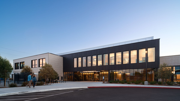 Early dusk shot of exterior of community center with a focus on the entrance of the building