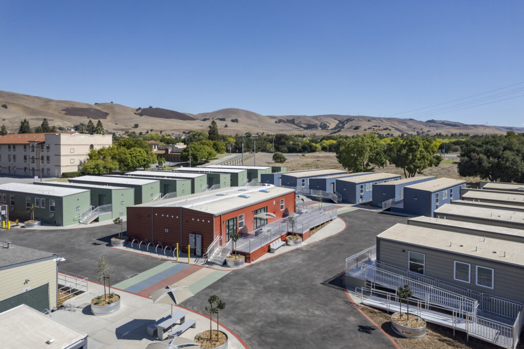 multi colored housing units surrounding one central building.