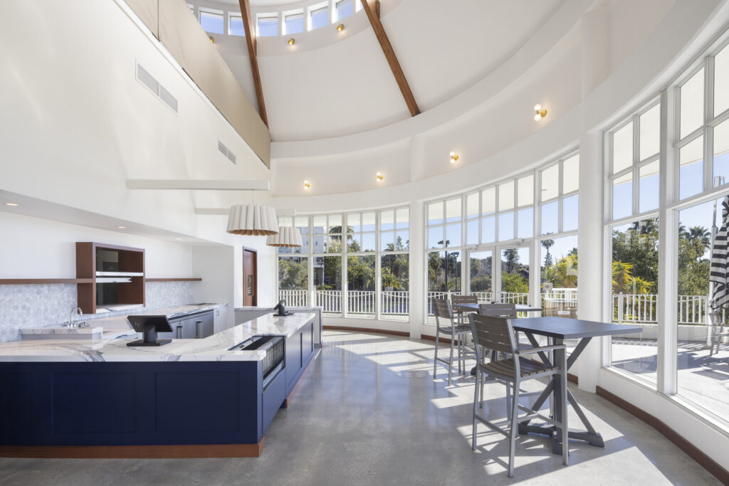 large open curved kitchen space, surrounded with floor to ceiling windows